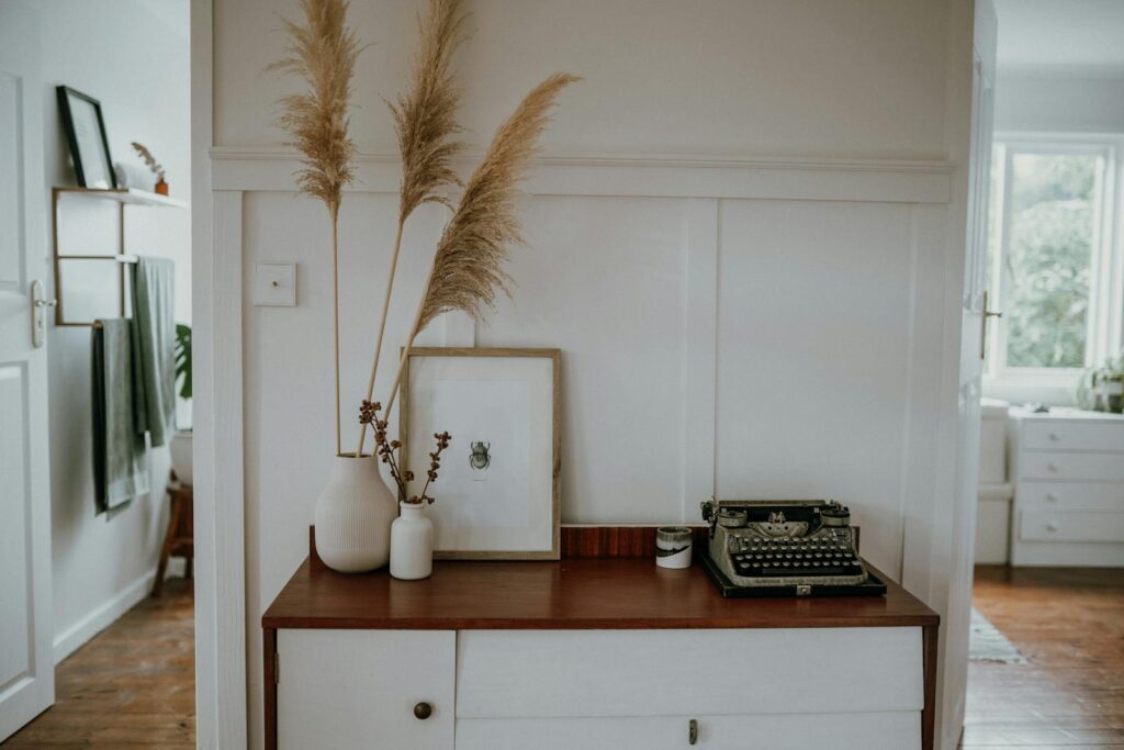 Elegant Scandinavian interior with pampas grass and vintage typewriter decor.