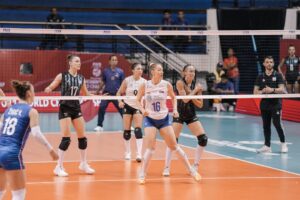 Players from Argentina and Serbia compete during a women's volleyball match at the FIVB U21 Women's World Championship in Surabaya, Indonesia, on July 15, 2023. The moment captures the intensity and fast-paced action of international youth volleyball
