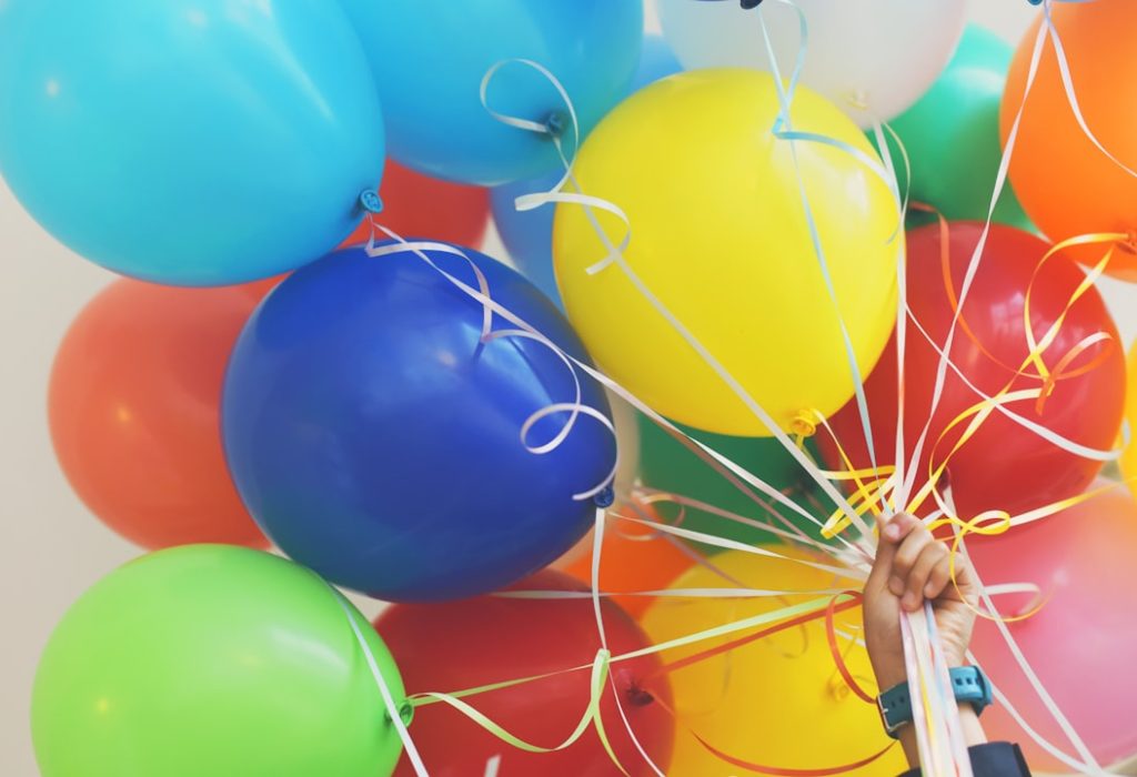 Holding colorful balloons